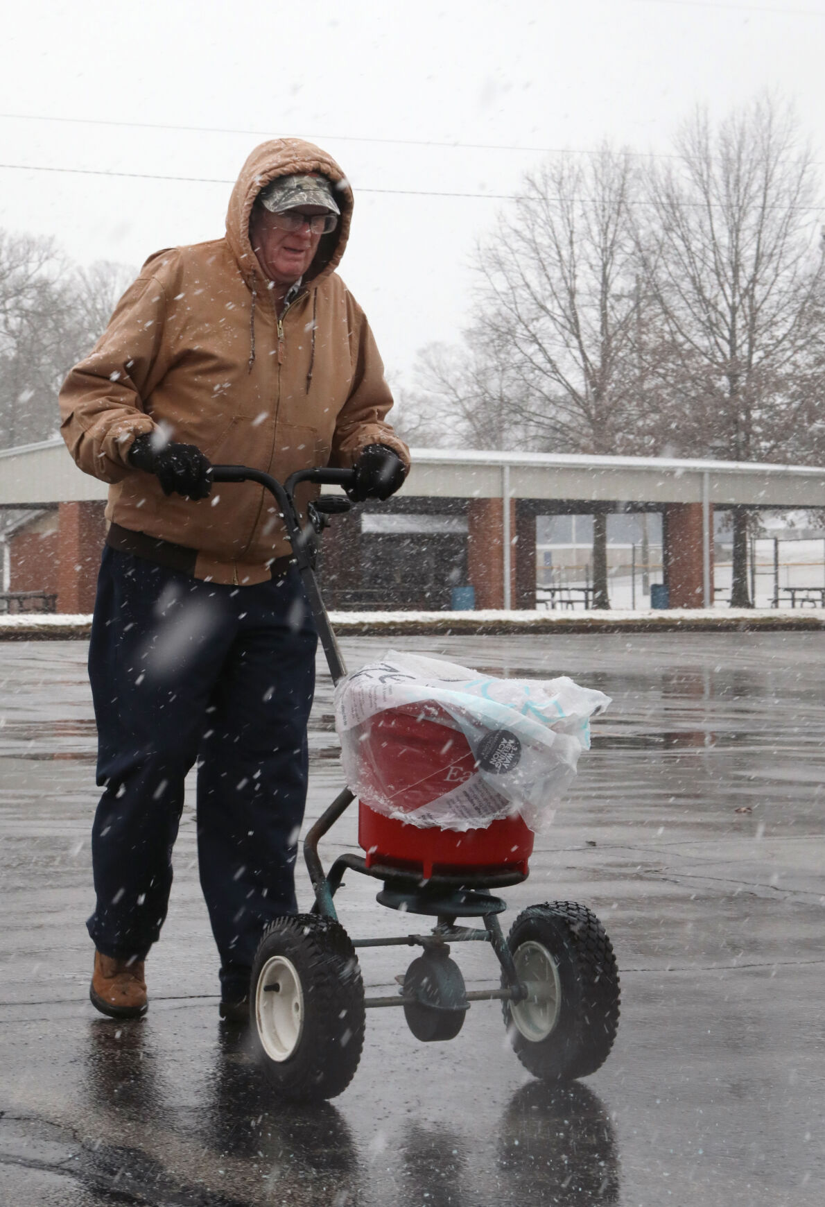 Floyd Meyer salts the KC Hall parking lot